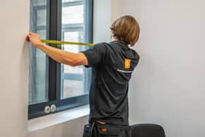Bridge surveyor measuring a window